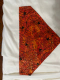 Halloween floral swirl pet bandanna in red and orange batik fabric with sparkle accents